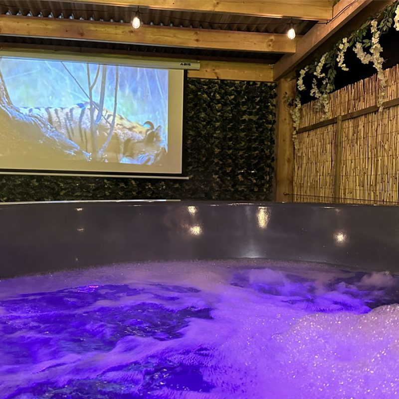 The hot tub and outdoor TV screen at the Great Glen glamping pod at Coorie Retreats