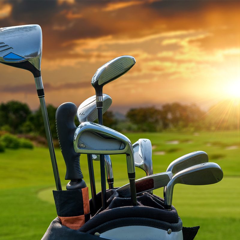 The Golf club bag for golfer training and play in game with golf course background , green tree sun rays.