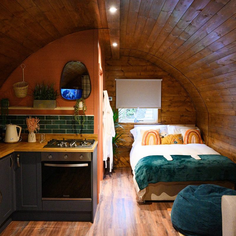 The kitchen and bed in the Bonnie Brae glamping pod at Coorie Retreats