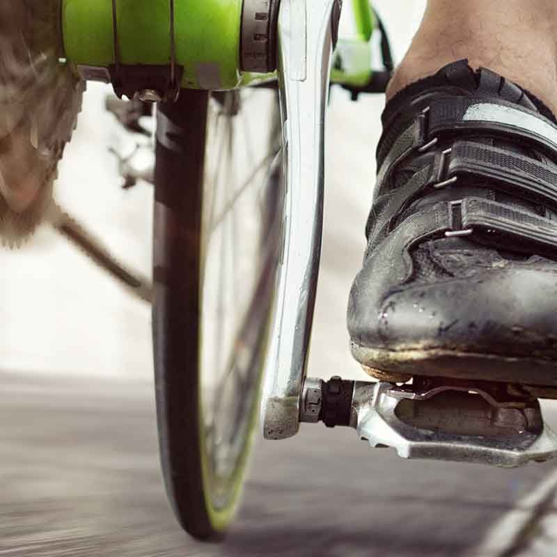 Close up of a cyclists pedal and foot.