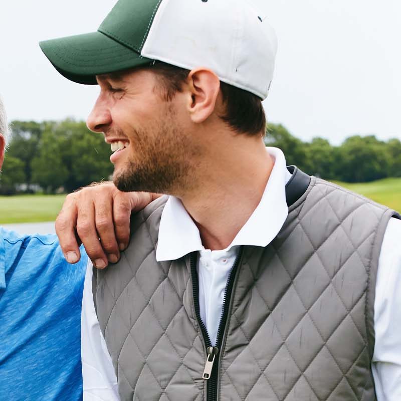 Two men happy on a golf course.